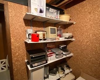 Small kitchen appliances, electronics and a Macintosh computer.