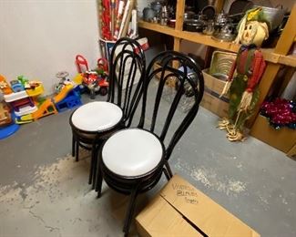 Four black metal cafe chairs,