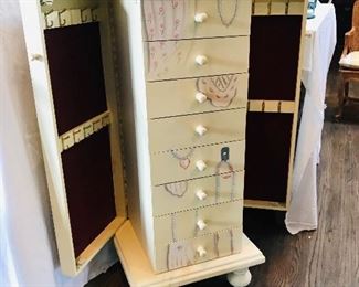 Jewelry box features a place for necklaces and drawers for other jewelry.