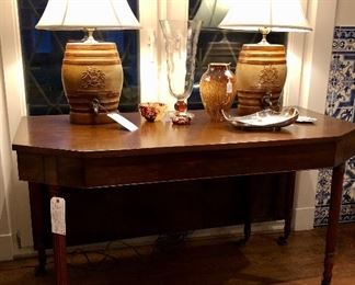 Pair of 19th century console tables which convert into a dining table, 53” wide!, pair of 19th century antique stoneware liquor casks, converted to lamps, Pairpoint vase, antique “Tortoise Shell” glass