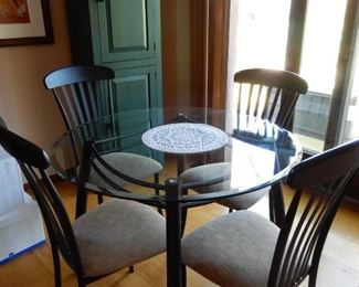 GLASS TOP TABLE AND 4 WROUGHT IRON CHAIRS $350.  NARROW GREEN CUPBOARD--CAN FIT ALMOST ANY PLACE   