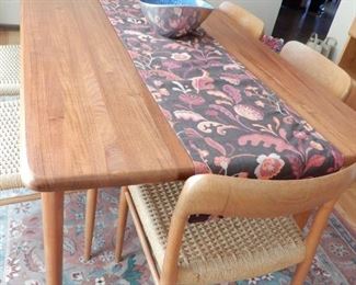 HOUSE OF DENMARK TEAK TABLE                                   
6'6" LONG BY 3'3" PLUS TWO LEAVES THAT ARE ADD ON END EXTENSIONS PLUS 6 TEAK AND ROPE WEAVE HANS WEGNER STYLE CHAIRS  $3000.