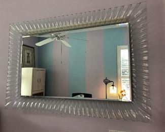 One of two glass frame wall mirrors