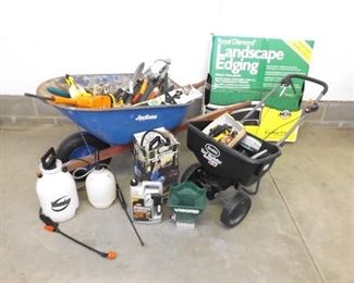 Wheelbarrow and Spreader Full of Misc Lawn and Garden Tools
