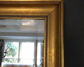 Detail shot of large beveled gilt framed mirror 