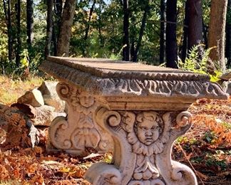 Item 27: Concrete bench with faces - 47.5”l x 15.25”w x 17”h: $150 - As Is