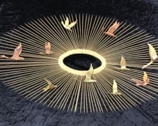 Wonderful mid century modern brass sunburst wall sculpture with flying copper and brass geese.
Varying length "rays" extending out from the oval center. The geese are copper and brass. Attributed to Friedle Bros. of New York, circa 1970s. 
Height: 20 Inches; Width: 38 Inches; Depth: 5 Inches
Description