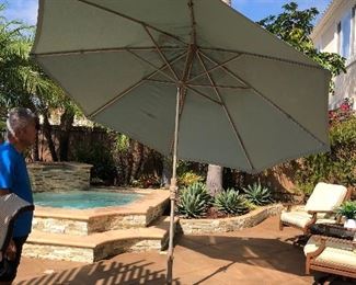 tilting Treasure Gardens Umbrella and stand 123" Circumference - plus a second one 9' wide still in the box.