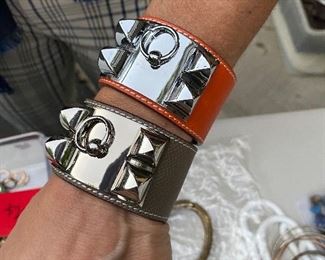 Hermes (not authentic, but amazing copies!) Collier de Chien Bracelets.  The  orange is priced at $100 and the Taupe is priced at $250.
