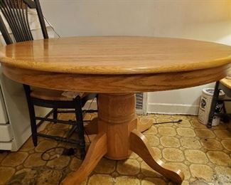 48" Oak Round Table with 5 Chairs. Chairs are wood with woven seats. 4 Chairs and 1 arm Chair. 24" Leaf - $300