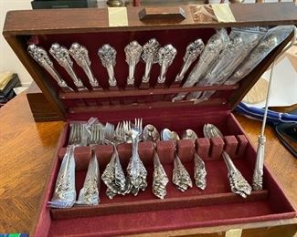 #73 Sterling Grand Baroque 							$2,900.00
69 pieces + 15 serving pieces = 84 pieces 		113.53 Total Oz 
   12 dinner knives  45.48
   12 dinner forks  36.24
   12 salad forks  18.84
   13 teaspoons  15.47
   8 soup spoons  17.52
   13 appetizer forks   11.44
   12 butter spreaders  
   large spoon 2.35
   smaller spoon 2.18
   large pierced spoon 2.18
   meat fork   2
   candle snuffer
   jelly spoon 1.09
   tomato server  3.30
   pierced small server 0.91
   gravy ladle  2.19
   cake server
   shell pattern server 
   pickle fork  2.10
   small pickle fork 0.8
   baby fork 0 .8
   baby spoon  0.82
