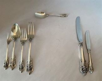 #73 Sterling Grand Baroque 							$2,900.00
69 pieces + 15 serving pieces = 84 pieces 		113.53 Total Oz 
   12 dinner knives  45.48
   12 dinner forks  36.24
   12 salad forks  18.84
   13 teaspoons  15.47
   8 soup spoons  17.52
   13 appetizer forks   11.44
   12 butter spreaders  
   large spoon 2.35
   smaller spoon 2.18
   large pierced spoon 2.18
   meat fork   2
   candle snuffer
   jelly spoon 1.09
   tomato server  3.30
   pierced small server 0.91
   gravy ladle  2.19
   cake server
   shell pattern server 
   pickle fork  2.10
   small pickle fork 0.8
   baby fork 0 .8
   baby spoon  0.82
