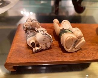 #112 - Ivory Netsuke Women w/Child & Fish    $125  signed - #113 - Ivory Netsuke with cup and drinking vessel   			 $125 signed 
