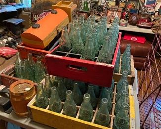 Lots of old Coca Cola bottles and crates.