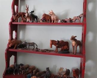 Red painted shelf and animal collection