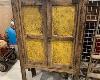 Early primitive antique punched tin pie safe with old mustard paint and interior shelves, from the island of Manteo NC