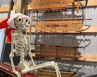 Assorted vintage sleds (one with biplane detailing)