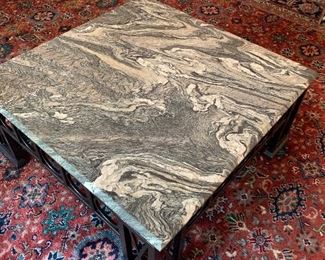 Large stone and iron coffee table. Also note the beautiful detail of the rug underneath.