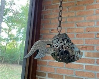 Heavy iron fish candle light, large, on a chair