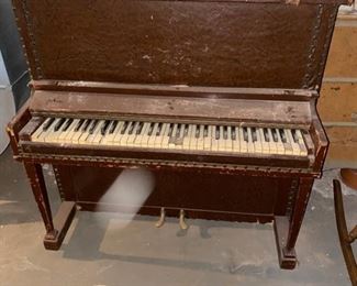 Leather-covered speakeasy piano.  Only 44 inches wide, 40 inches high, 22 inches deep from front to back.  The keyboard is 36 inches across.  It is needs much work.  