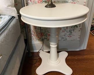 Round white pedestal table, one of two