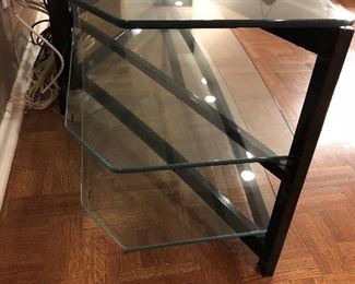 detail of Black metal & 3 glass shelf media stand - angled glass shelves