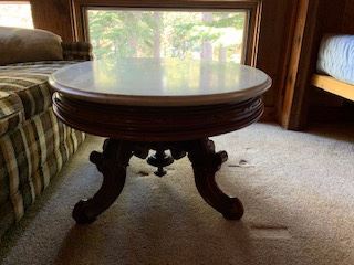 Coffee table 36” x 28” oval, 19” high, 1”thick marble top, ornately carved solid mahogany base. 