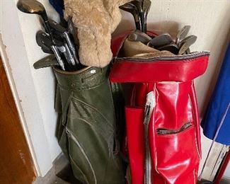 two sets of golf clubs 