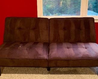 Item 82:  Futon type sofa/bed is black suede-cloth folds flat easily for an extra emergency sleeping spot! Small white spot on left seat cushion - 67.5"l x 28.5"w x 27.5"h:  $95