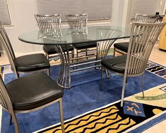Item 84:  The Genesis contemporary dining table and chairs by Johnston Casuals is absolutely gorgeous.  All welded and handmade in the U.S. (4). Made by Johnston Casuals. Chairs have black leather seat cushions: $2100 for all!                                                                                 Table - 72"l x 42"w x 30"h                                                                                   Chairs - 18.5"l x 17.5"w x 38.5"h