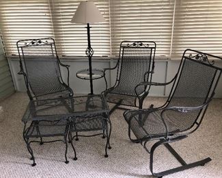 Woodard patio set with four chairs, nesting tables and polarized lamp.