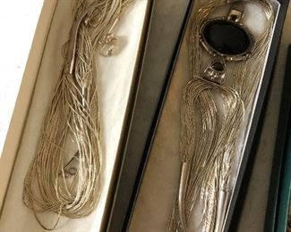 Sterling silver necklaces and other jewelry pieces.