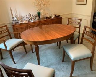 Dining table with two armchairs, four side chairs, two additional leaves and table pads.