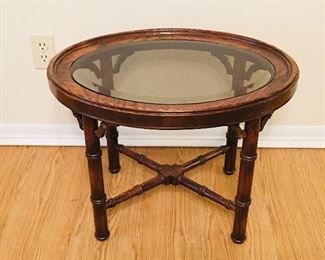 Oval side table with glass. Dimensions are 23 inches wide by 17 inches deep by 18 inches tall. 