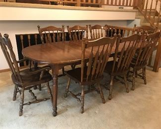 Dining table with 8 chairs, pictured with 2 leaves