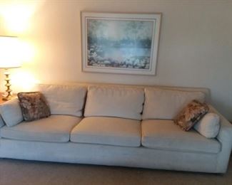7 Foot Long Off White Sofa Reupholstered by The Fabric Place of Kentwood; wall decor; modern lamps