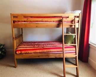 Two sets of rustic bunk beds with ladders