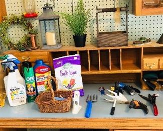 Garden hand tools $1 ea. Garden fertilizers and pesticides (BULB TONE SOLD) $1 ea. Basket of laundry clips $3. Lantern $5. Wreath $5. Faux plant $3. Wooden basket $10. Metal funnel $2. Floral frog set of three $5. Bulb planter $2. 