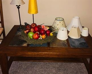 Wooden coffee table with slate top 48" x 28" on wheels $70. Lamps $19 ea. Lamp shades $4 ea. Fruit bowl $10. 