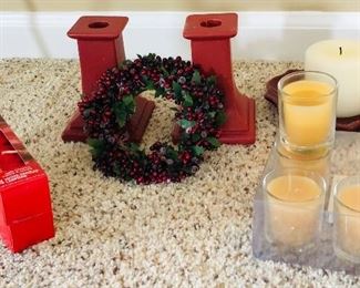 Red candlesticks 5" high $5 pr. Yellow votives $2. Two boxes of red votives $2. Wreath $2 (sold). Cranberry plate with candle $2.
