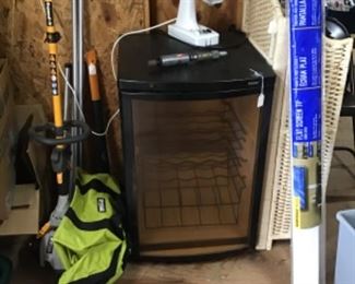 weed eater, shelf, mini drink fridge
