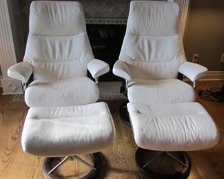 Two Stressless Mayfair white leather upholstered recliners with ottomans. Like new. Chair H 42 ½”, W 33”, D 23” $1,500 each