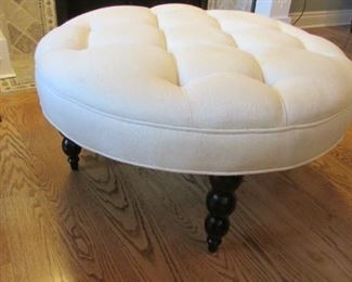 Linen upholstered button tufted ottoman. The linen with a watermark.  H 17”, Diameter 35” $200
