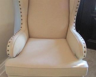 Linen upholstered wing chair with nail head trim. With stain on one arm rest. The back leg is loose. H 47”, W 30”, D 31 $200