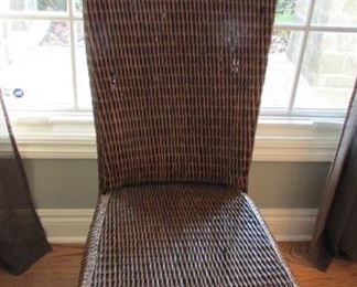 Woven rattan high back side chair.  The rattan is split in 2 places on the seat.  H 42”, W 19”, D 18” $50