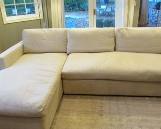 Restoration Hardware down filled sectional sofa.  Cream cotton upholstery.  Few minor spots to the armrests.  The front apron is slightly discolored.  H 31”, L 106”, D 41 ½”, chaise L 73” $2,300
