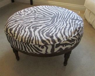 Quatirne slip covered ottoman. H 17”, D 35 1/2” $200