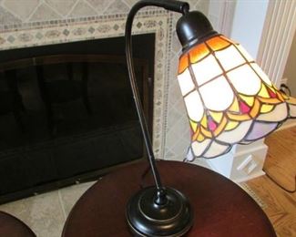 Bronze finished and leaded glass table lamp. H 18 ½”, shade length 7 ½”, Diameter 6 ½” $70
