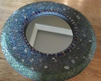 Glass framed round mirror. Diameter 20” $35