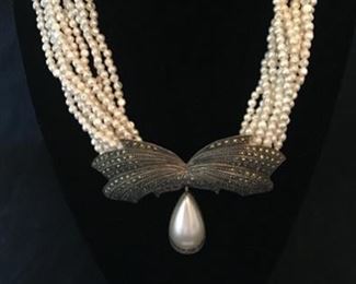 STUNNING STERLING AND MARCASITE BOW DESIGN WITH LARGE HANGING TEARDROP MOTHER OF PEARL ON 10 STRANDS OF SMALL FRESHWATER PEARLS WITH STERLING CLASP